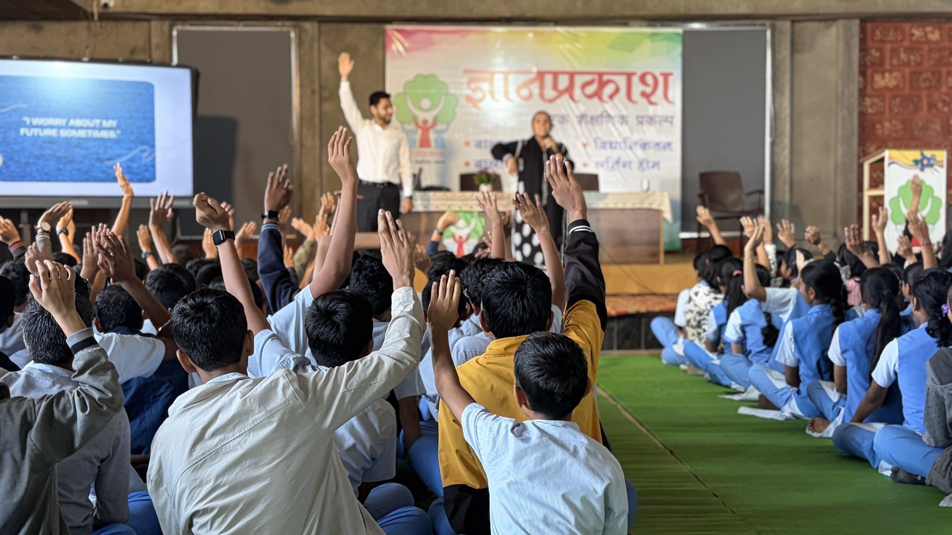 Babson College alumni addressing Dnyanprakash students during the mentoring session — students raising their hands in response